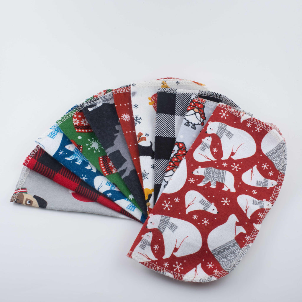 Set of festive cloth kids napkins with various holiday patterns on a white background